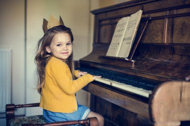 Adorable Girl Playing Piano clipart