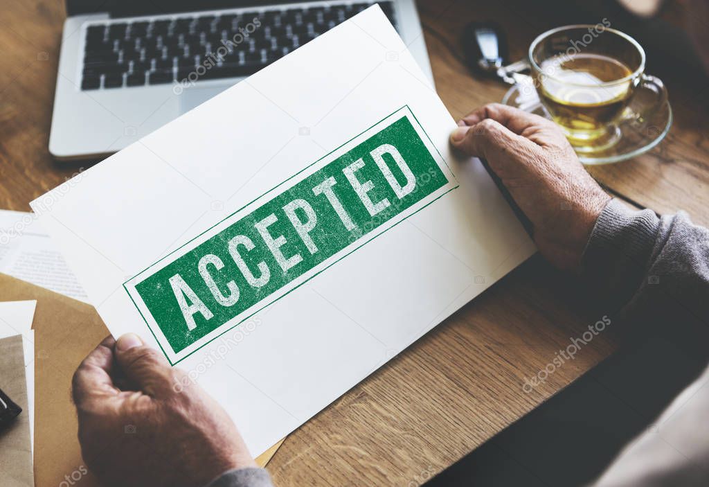 person holding paper at wooden table