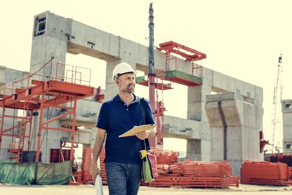 Trabalhador da construção civil com plano de arquitetura — Fotografia de Stock