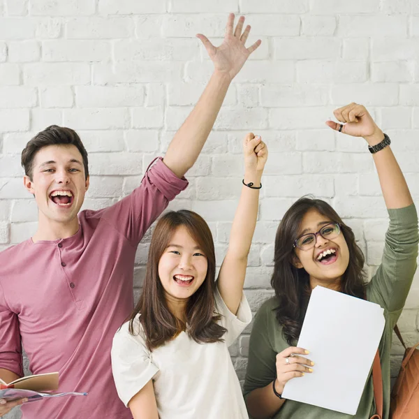 Students standing against white wall — Stock Photo, Image