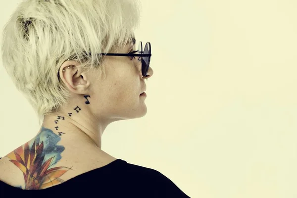 Woman with tattoos posing in studio — Stock Photo, Image