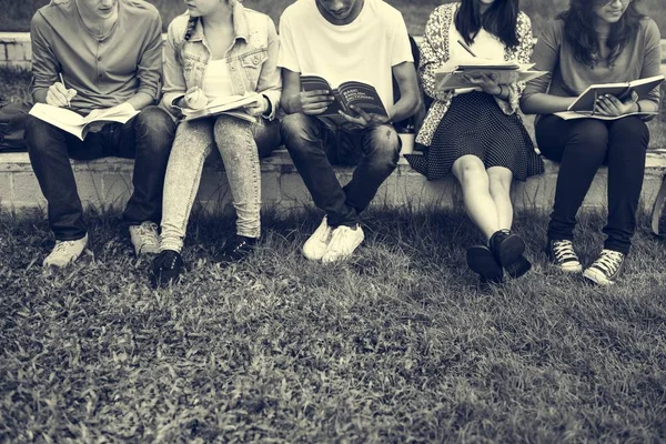 Schüler sitzen im Park — Stockfoto