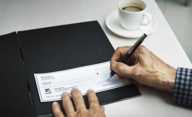 man writing signature in checkbook clipart