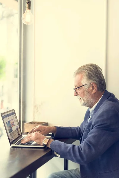 Senior man met laptop — Stockfoto