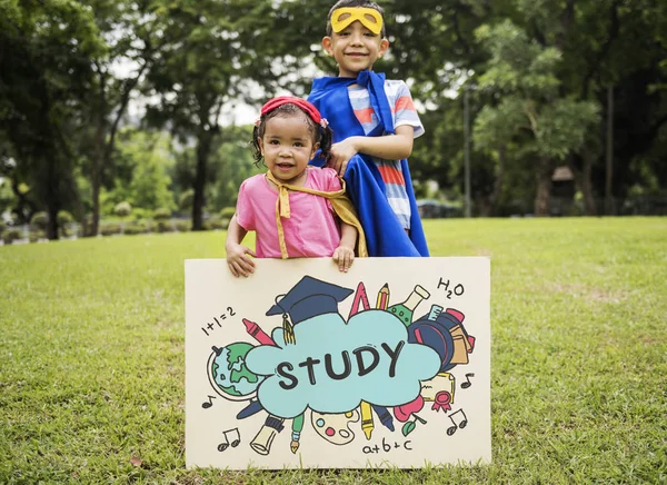 Superhéroe Niños con tabla en las manos —  Fotos de Stock