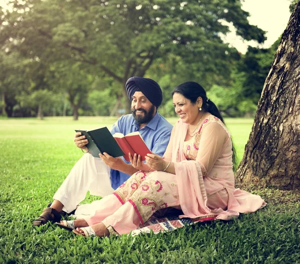 Beautiful Indian Couple reading books — Stock Photo, Image