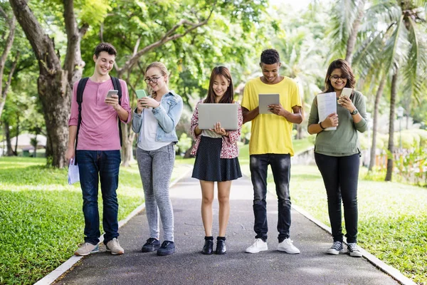 Friends Walking and using digital devices — Stock Photo, Image