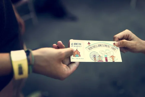 friends hands holding ticket