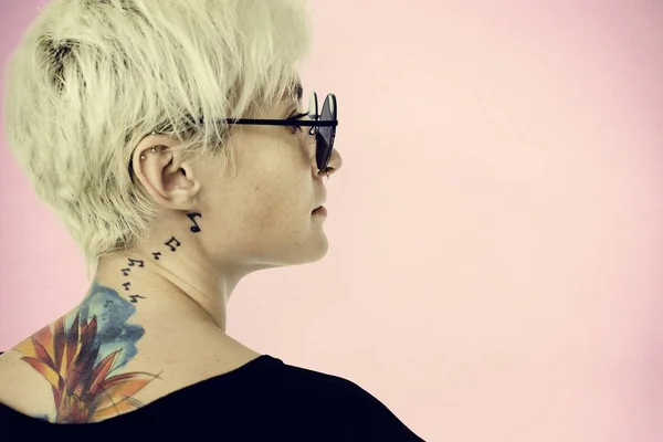 Woman with tattoos posing in studio — Stock Photo, Image