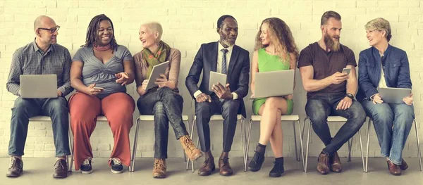 Menschen sitzen auf Stühlen — Stockfoto