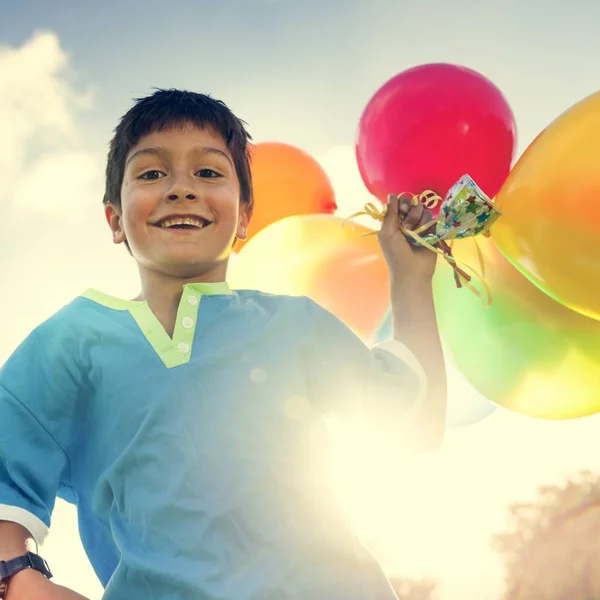 Boy playing with balolons — Stock Photo, Image