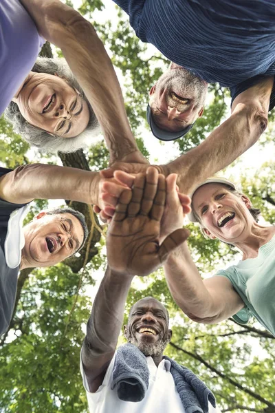 Amigos mayores dándose la mano — Foto de Stock