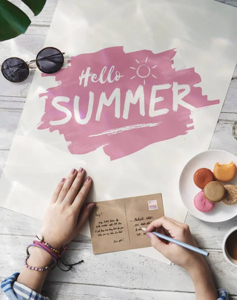 Woman writing wishes on postcard — Stock Photo, Image