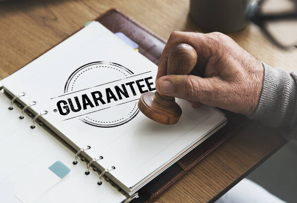 man putting stamp in diary