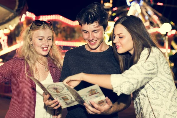 Friends in Amusement Park with map — Stock Photo, Image