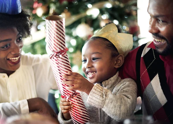 Little girl opens a festive gift — Stock Photo, Image