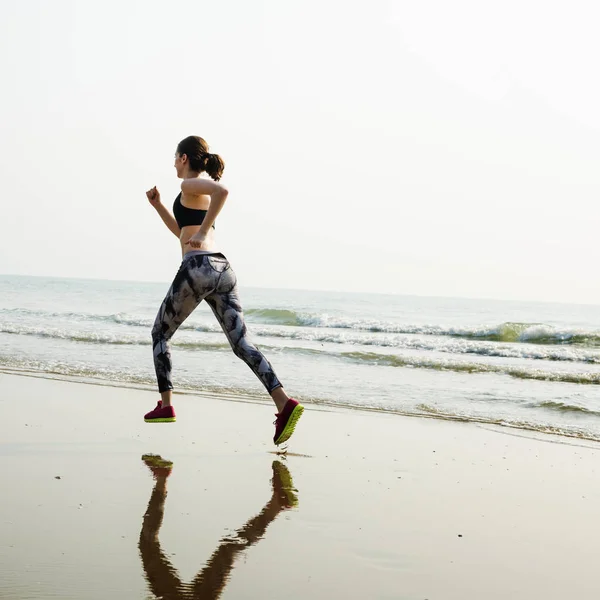 Mujer deportiva Correr en la playa —  Fotos de Stock