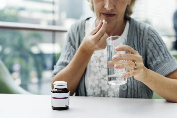 Woman drinking pills — Stock Photo, Image