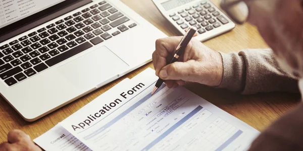 Homem sênior escrevendo em formulário de inscrição — Fotografia de Stock