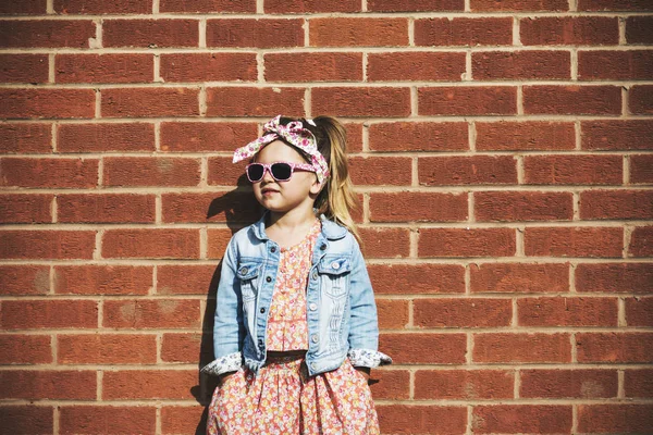 Fashionista menina contra parede de tijolo — Fotografia de Stock