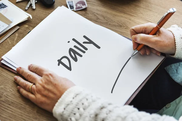 Person writing on white paper — Stock Photo, Image