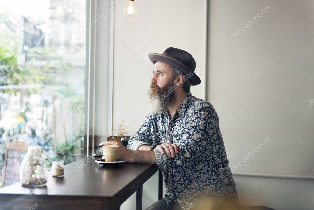 hipster man in hat sitting in cafe