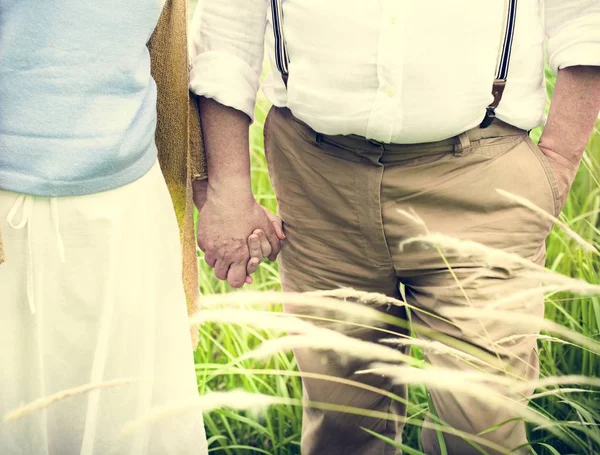 Elderly Couple in Love holding hands — Stock Photo, Image