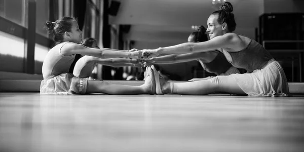 ballerinas stretching in Ballet Training School