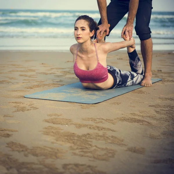 Koppel doen yoga op het strand — Stockfoto