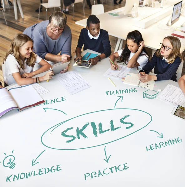 Senior teacher with pupils at school — Stock Photo, Image