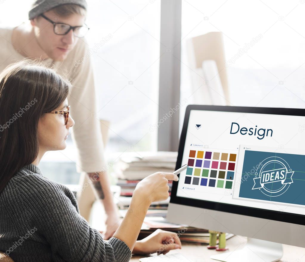 Team working in office, woman showing on monitor with Design