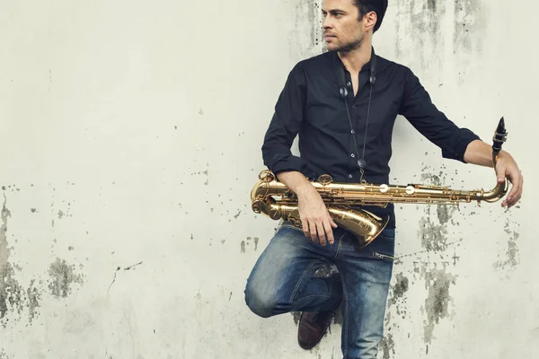 Handsome Jazzman holding Saxophone — Stock Photo, Image