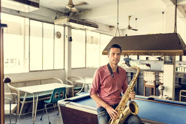 Handsome Jazzman holding Saxophone — Stock Photo, Image