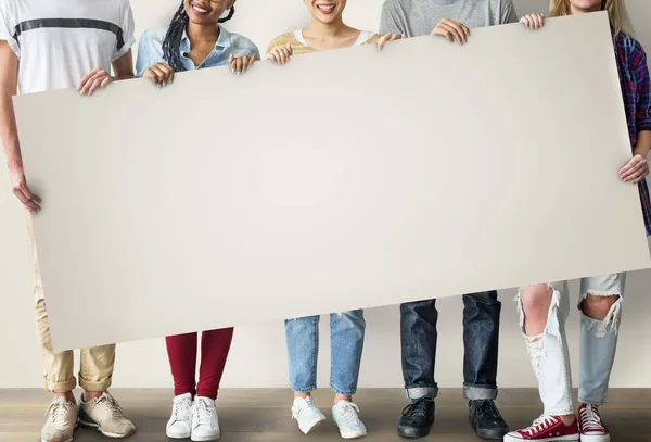 Students holding informational board — Stock Photo, Image