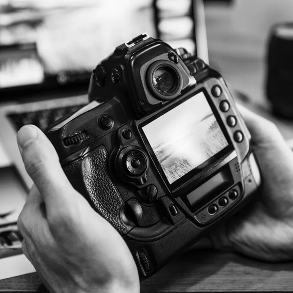 Photographer looking photos on the camera — Stock Photo, Image