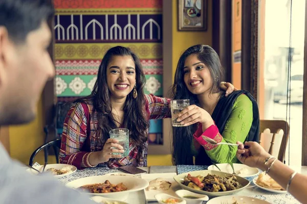 beautiful Indian friends in restaurant