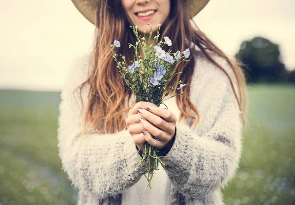 Красива жінка тримає квіти — стокове фото