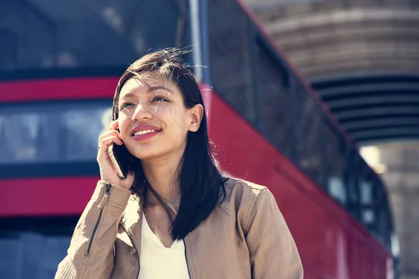 Ung kvinna pratar på mobiltelefon — Stockfoto