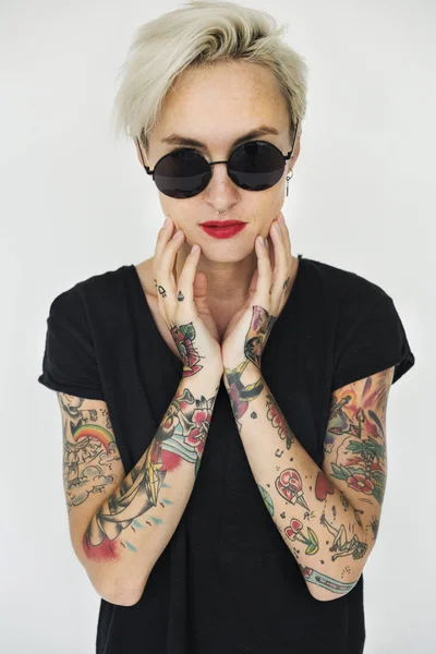 Woman with tattoos posing in studio — Stock Photo, Image