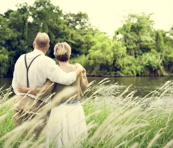 Mature couple standing in park — Stock Photo, Image