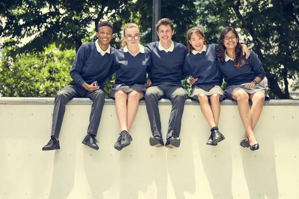 Olika studenter i skoluniform — Stockfoto