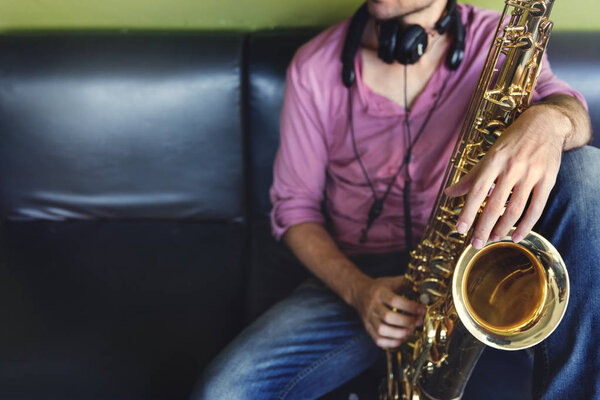 Musician holding Saxophone Stock Image