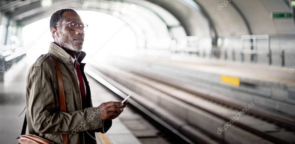 african man using smartphone