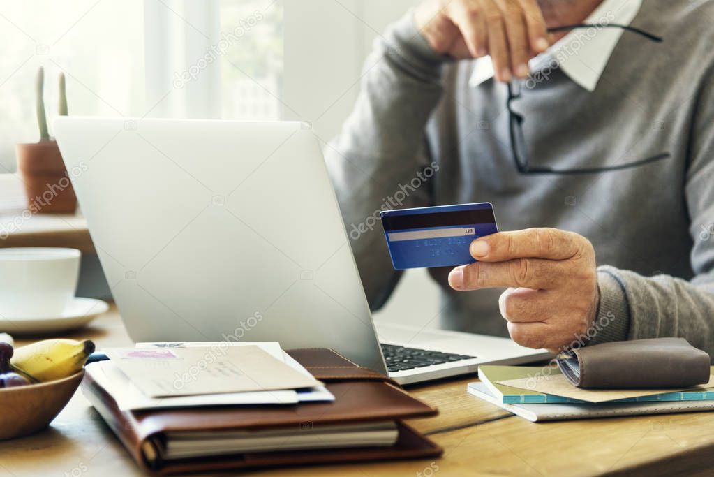 person with credit card and laptop