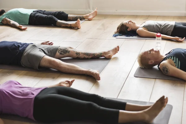 Gente acostada en alfombra de yoga —  Fotos de Stock