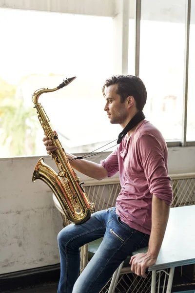 Musician holding Saxophone — Stock Photo, Image