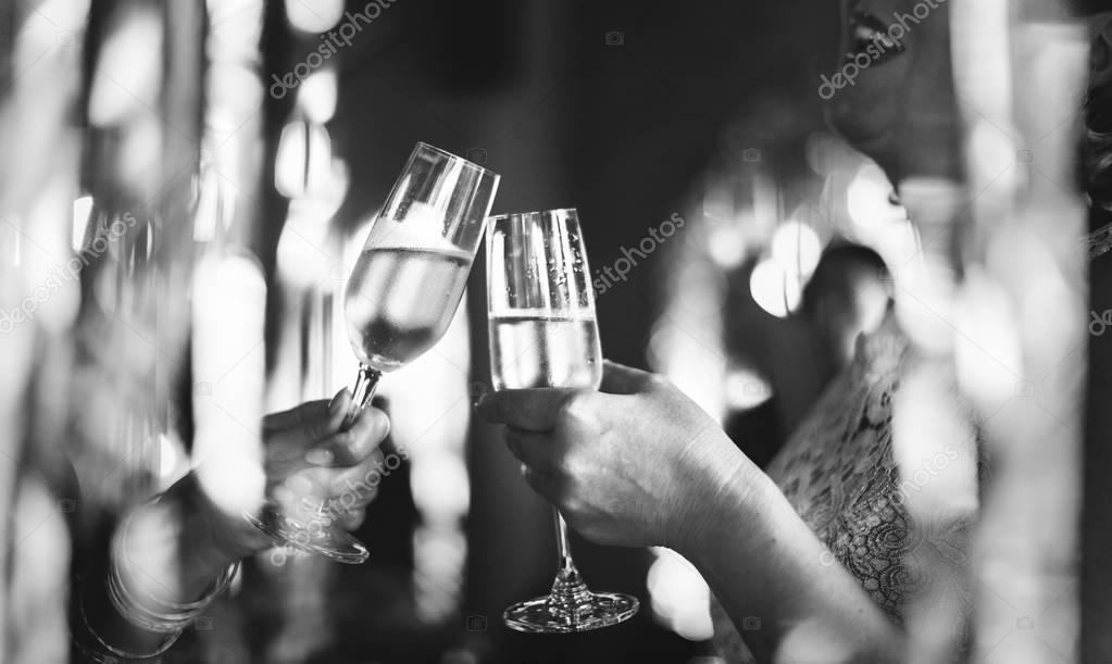 people cheers with glasses of champagne