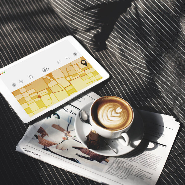 digital tablet and coffee cup