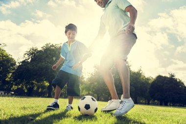 Baba ve küçük çocuk oynarken futbol 