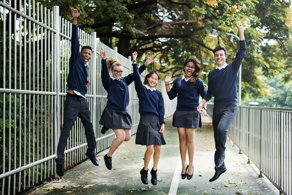 Olika studenter i skoluniform — Stockfoto